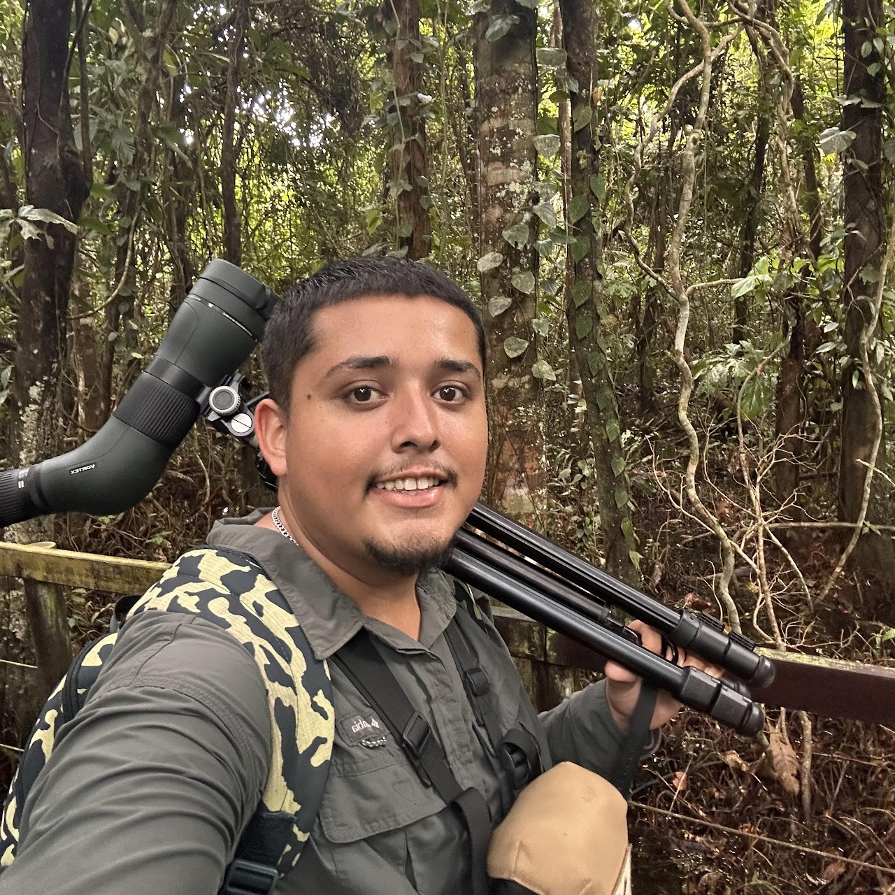 Alonso with spotting scope telescope set up on trail birdwatching